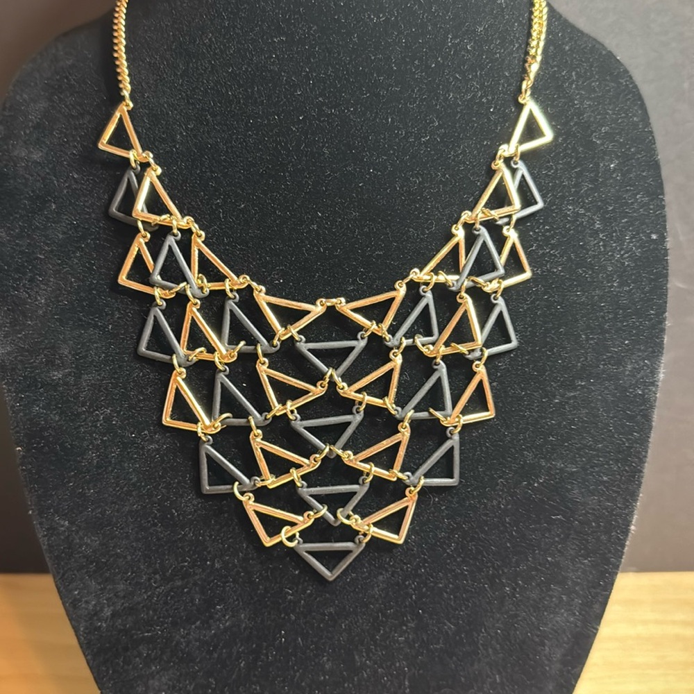 Gold tone and black triangle bib necklace